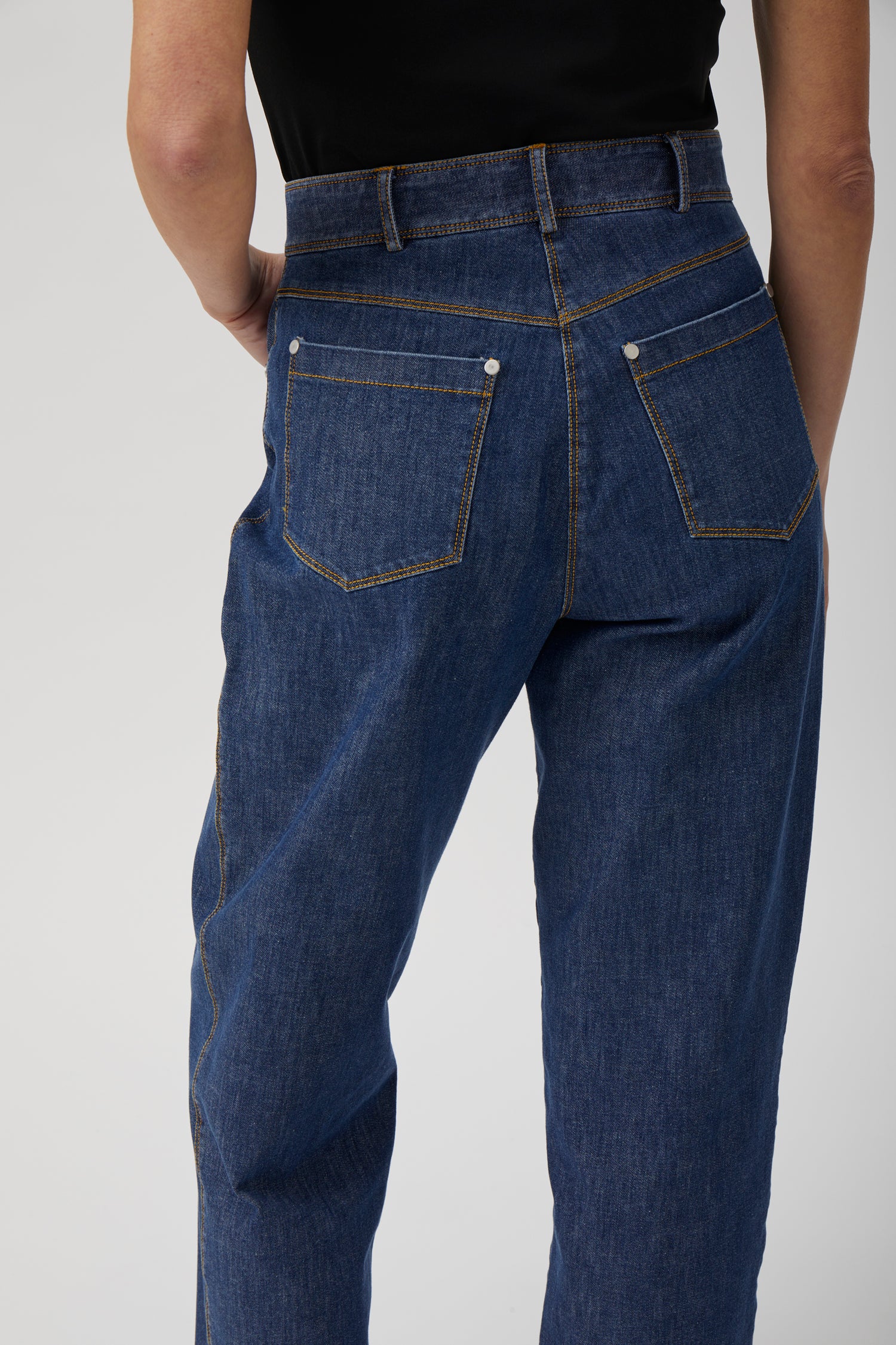 Back view of relaxed straight-leg washed blue denim jeans