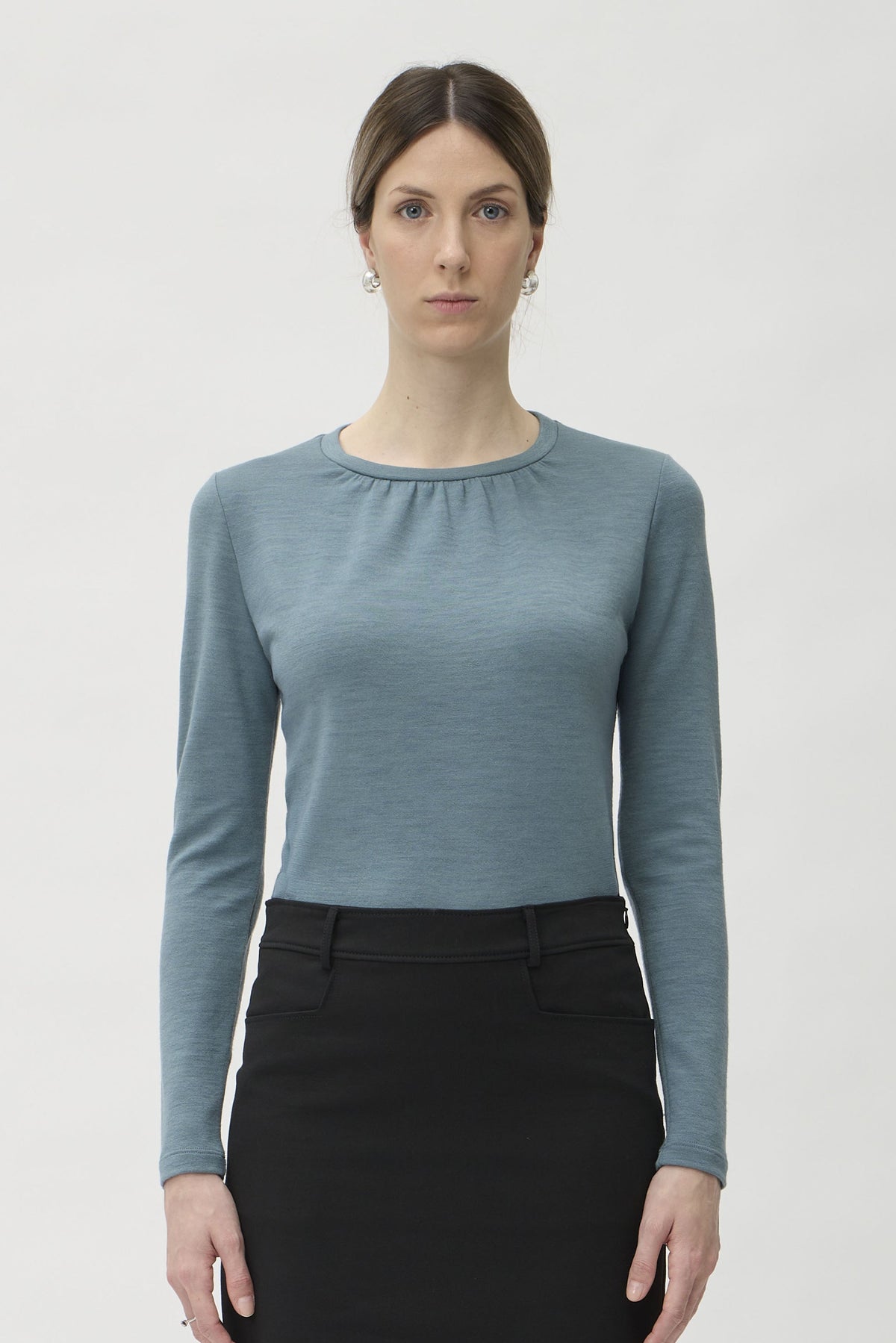 Blouse Wrinkled Neckline in Darfo 1200 Green Blue – model full length front view styled with black midi skirt – ELISE GUG