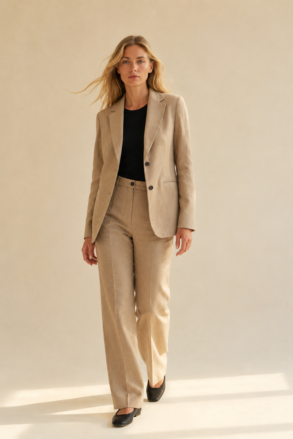 Blonde model wearing camel linen blazer and wide-leg trousers by ELISE GUG