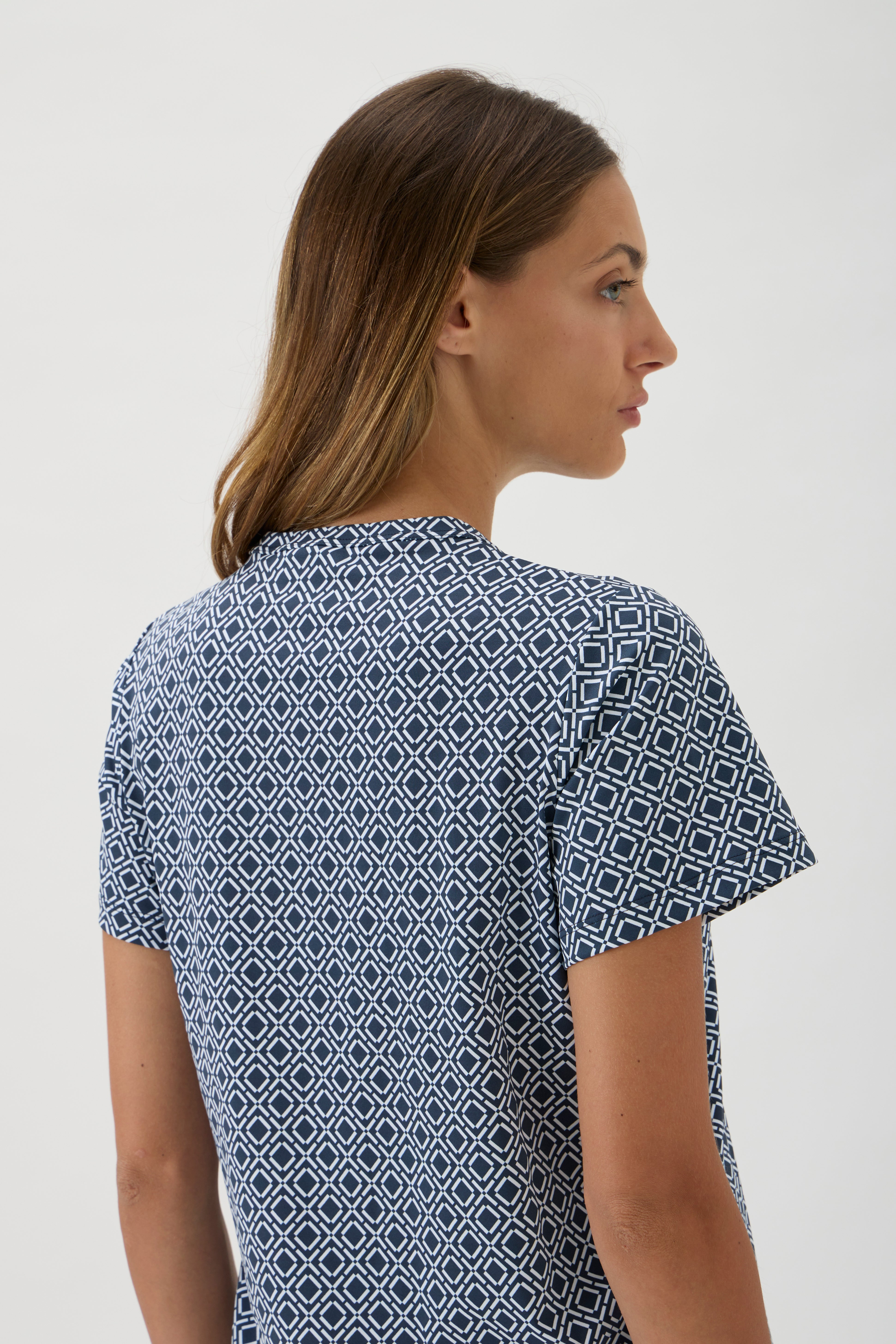 Close-up of geometric blue print jersey fabric and refined tailoring details
