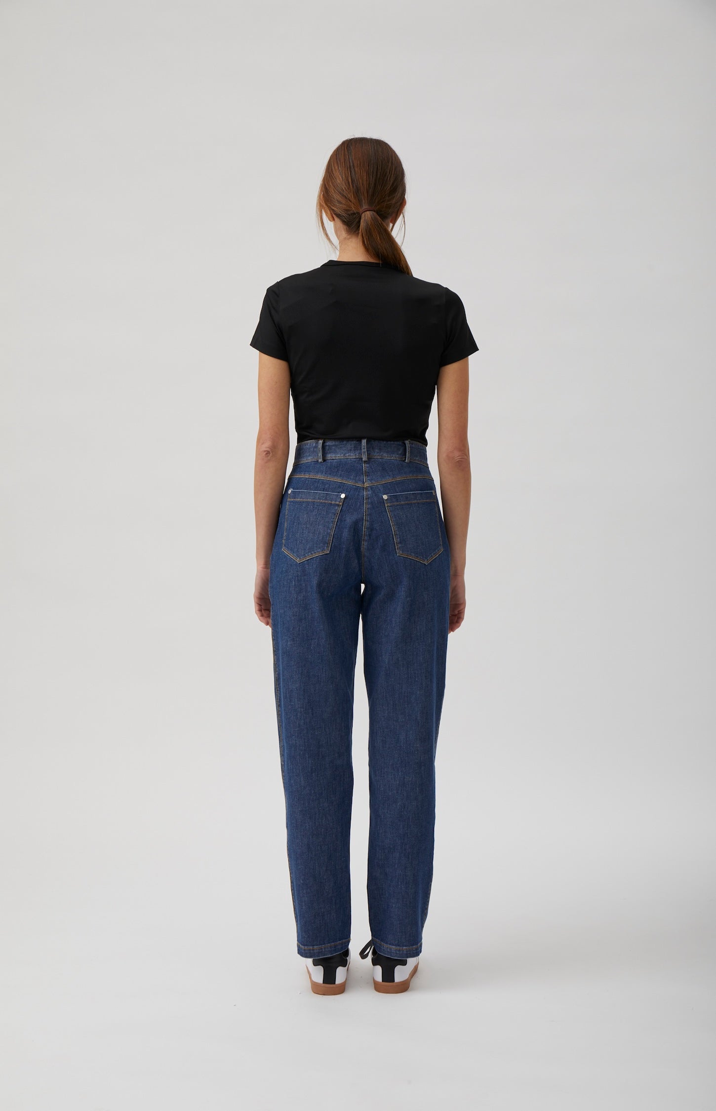 Back view of relaxed straight-leg washed blue denim jeans