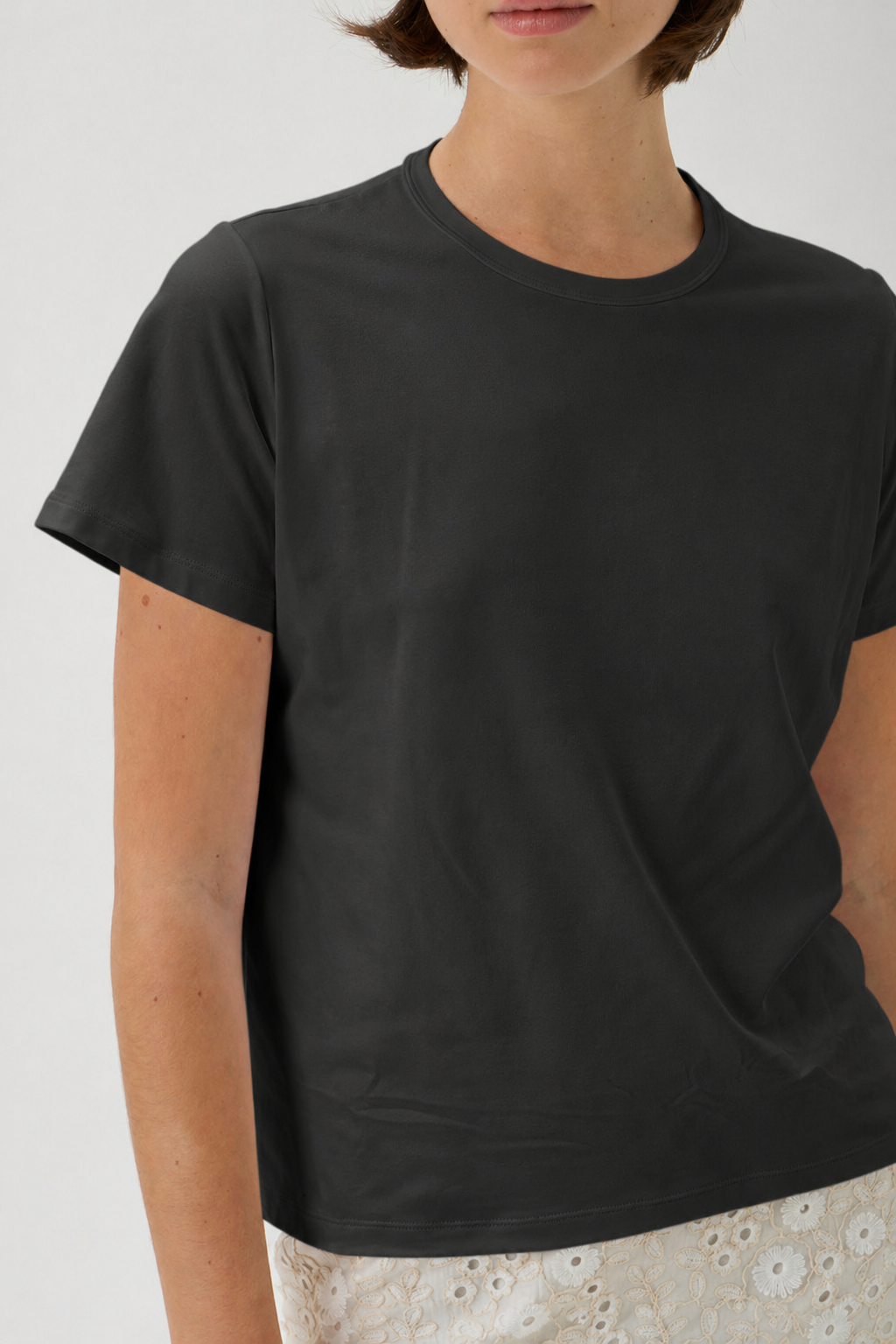 Close-up of luxury black crew neck T-shirt in soft NAIR jersey fabric